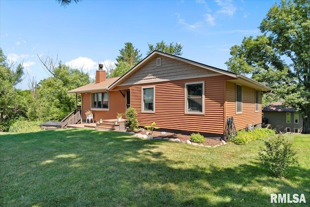 129 Glenview Dr, Sherrard, IL 61281 - back of property with a chimney and a yard