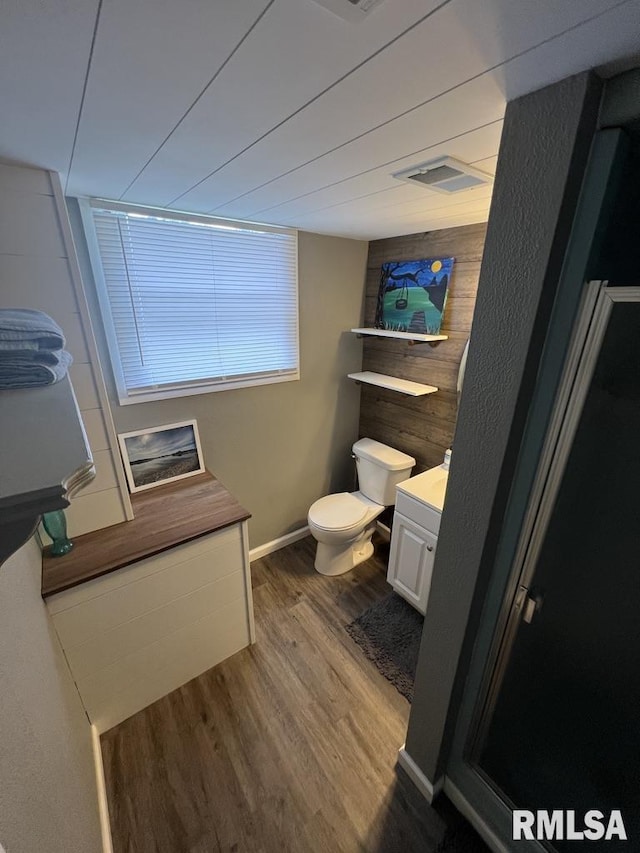 129 Glenview Dr, Sherrard, IL 61281 - bathroom featuring wood finished floors, vanity, and wooden walls