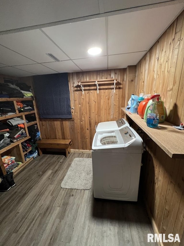 129 Glenview Dr, Sherrard, IL 61281 - washroom featuring washing machine and clothes dryer, wooden walls, and wood finished floors