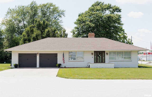 300 S 1st St, Camp Point, IL 62320 - single story home with a garage, driveway, a front yard, and brick siding