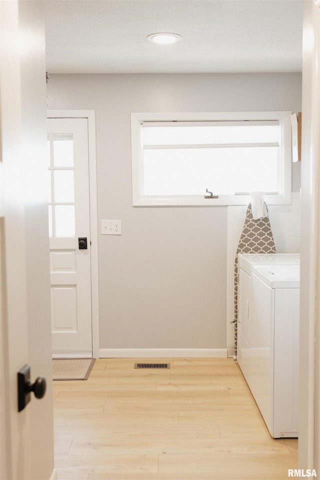 300 S 1st St, Camp Point, IL 62320 - laundry room featuring separate washer and dryer, light wood-style flooring, and plenty of natural light