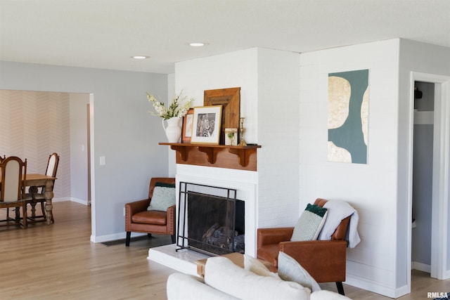 300 S 1st St, Camp Point, IL 62320 - living area featuring light wood-type flooring, a fireplace with raised hearth, and recessed lighting