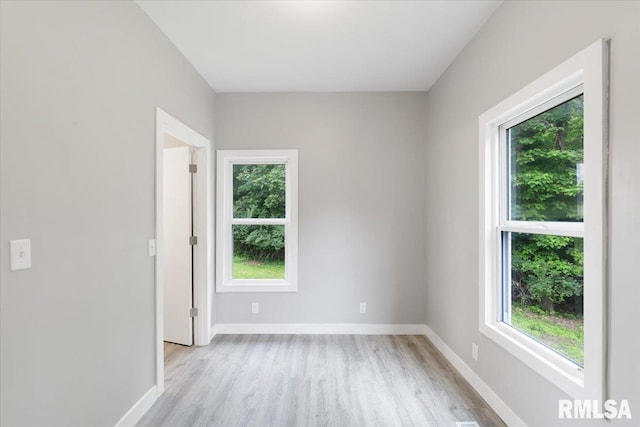 619 51st St, Moline, IL 61265 - empty room featuring healthy amount of natural light and light wood-style flooring