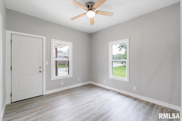 619 51st St, Moline, IL 61265 - unfurnished room with healthy amount of natural light, light wood finished floors, and ceiling fan