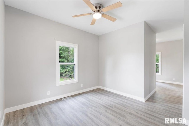 619 51st St, Moline, IL 61265 - spare room with plenty of natural light, wood finished floors, and ceiling fan