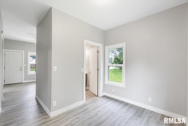 619 51st St, Moline, IL 61265 - spare room featuring wood finished floors and baseboards