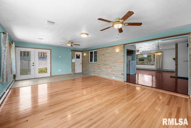 22 Pleasant View Dr, Annawan, IL 61234 - unfurnished living room with hardwood / wood-style flooring, french doors, ceiling fan, and baseboard heating