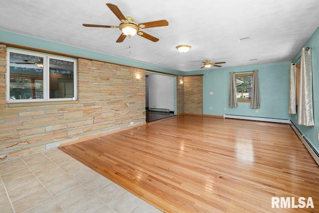 22 Pleasant View Dr, Annawan, IL 61234 - empty room featuring ceiling fan, a baseboard heating unit, and tile patterned floors