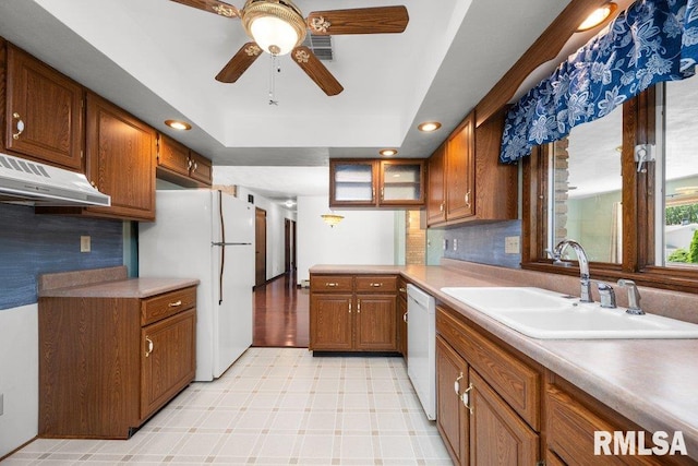 22 Pleasant View Dr, Annawan, IL 61234 - kitchen featuring white appliances, brown cabinetry, under cabinet range hood, ceiling fan, and a peninsula