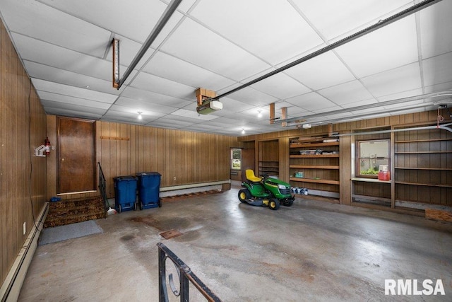 22 Pleasant View Dr, Annawan, IL 61234 - garage featuring wooden walls, a baseboard radiator, and a garage door opener