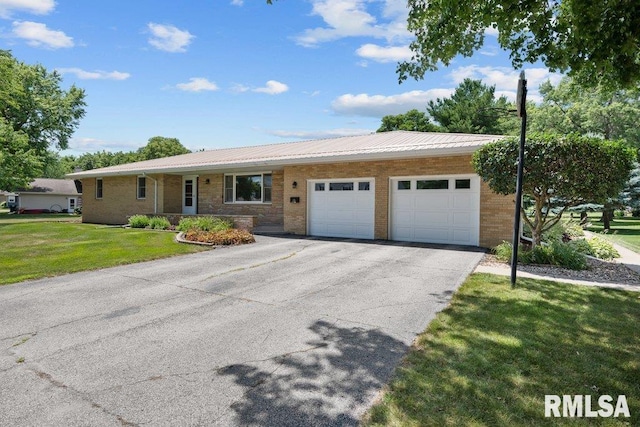 22 Pleasant View Dr, Annawan, IL 61234 - ranch-style home with an attached garage, driveway, a front yard, a metal roof, and brick siding