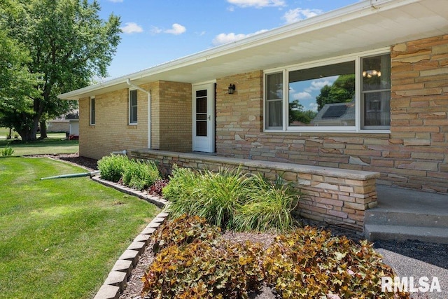 22 Pleasant View Dr, Annawan, IL 61234 - view of exterior entry with a lawn and stone siding