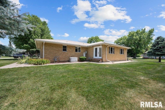 22 Pleasant View Dr, Annawan, IL 61234 - back of property with french doors, a lawn, and brick siding
