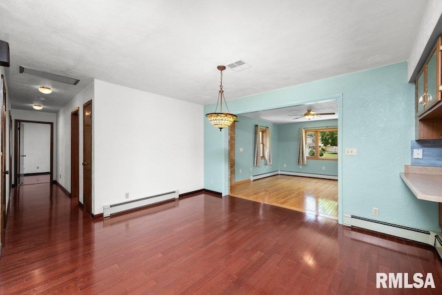 22 Pleasant View Dr, Annawan, IL 61234 - unfurnished dining area with baseboard heating, wood finished floors, and ceiling fan