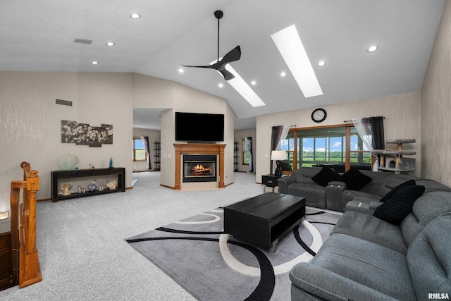 12828 25th Street Ct, Milan, IL 61264 - living room with a skylight, light carpet, high vaulted ceiling, recessed lighting, and a glass covered fireplace