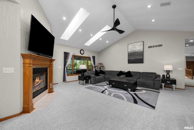 12828 25th Street Ct, Milan, IL 61264 - carpeted living area with vaulted ceiling, a skylight, a fireplace with flush hearth, and recessed lighting