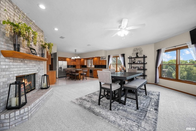 12828 25th Street Ct, Milan, IL 61264 - dining area with light carpet, a fireplace, ceiling fan, and recessed lighting