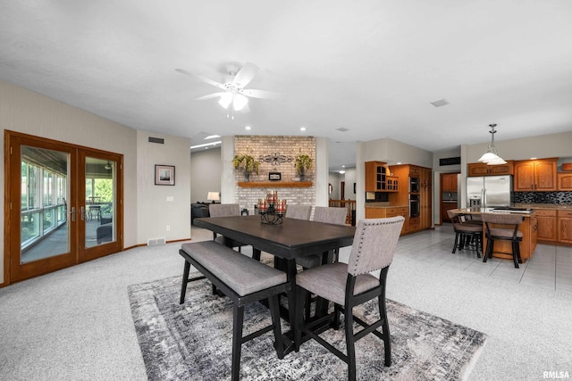 12828 25th Street Ct, Milan, IL 61264 - dining area featuring french doors, light carpet, and ceiling fan
