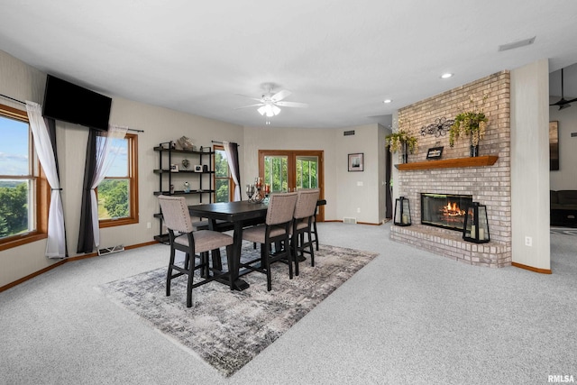 12828 25th Street Ct, Milan, IL 61264 - dining room with light carpet, a ceiling fan, a brick fireplace, and recessed lighting
