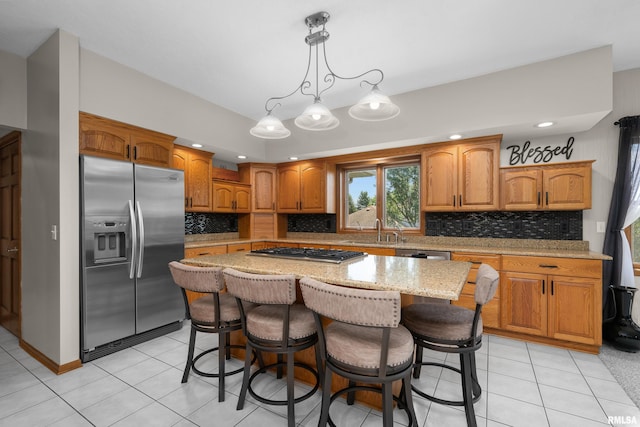 12828 25th Street Ct, Milan, IL 61264 - kitchen with appliances with stainless steel finishes, backsplash, a kitchen island, light stone countertops, and recessed lighting