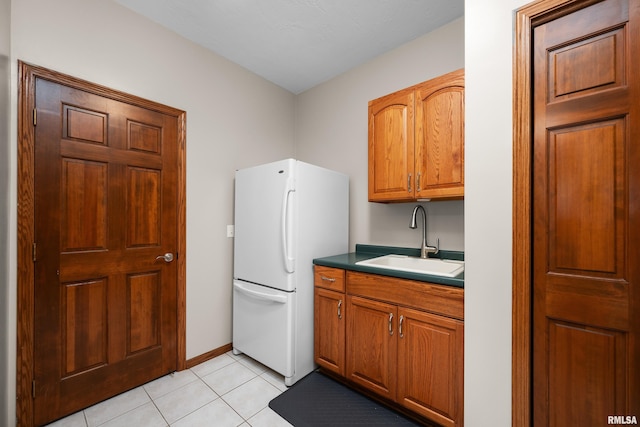 12828 25th Street Ct, Milan, IL 61264 - kitchen featuring freestanding refrigerator, light tile patterned flooring, and brown cabinets