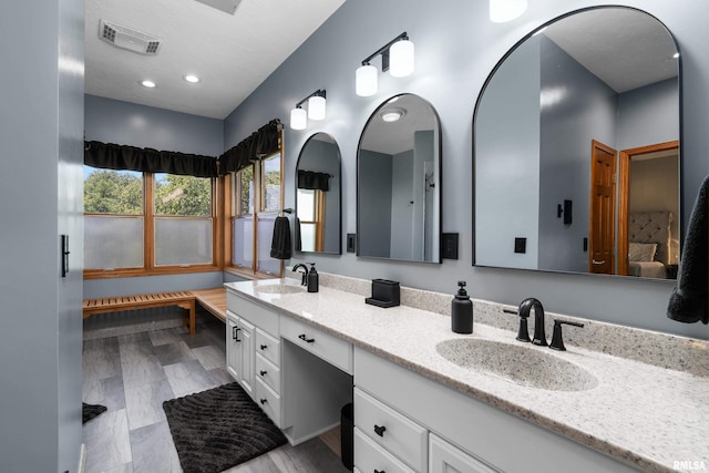 12828 25th Street Ct, Milan, IL 61264 - bathroom featuring double vanity, ensuite bath, and recessed lighting