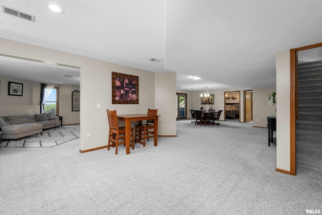 12828 25th Street Ct, Milan, IL 61264 - dining area featuring carpet flooring, stairway, and a chandelier