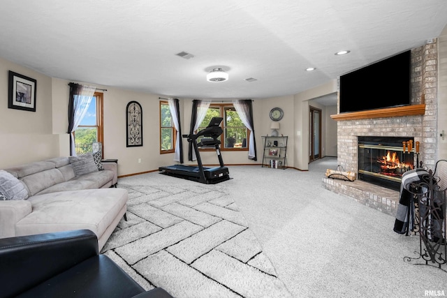 12828 25th Street Ct, Milan, IL 61264 - living area featuring carpet flooring, a fireplace, healthy amount of natural light, and recessed lighting