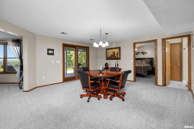 12828 25th Street Ct, Milan, IL 61264 - carpeted dining space featuring a chandelier and healthy amount of natural light