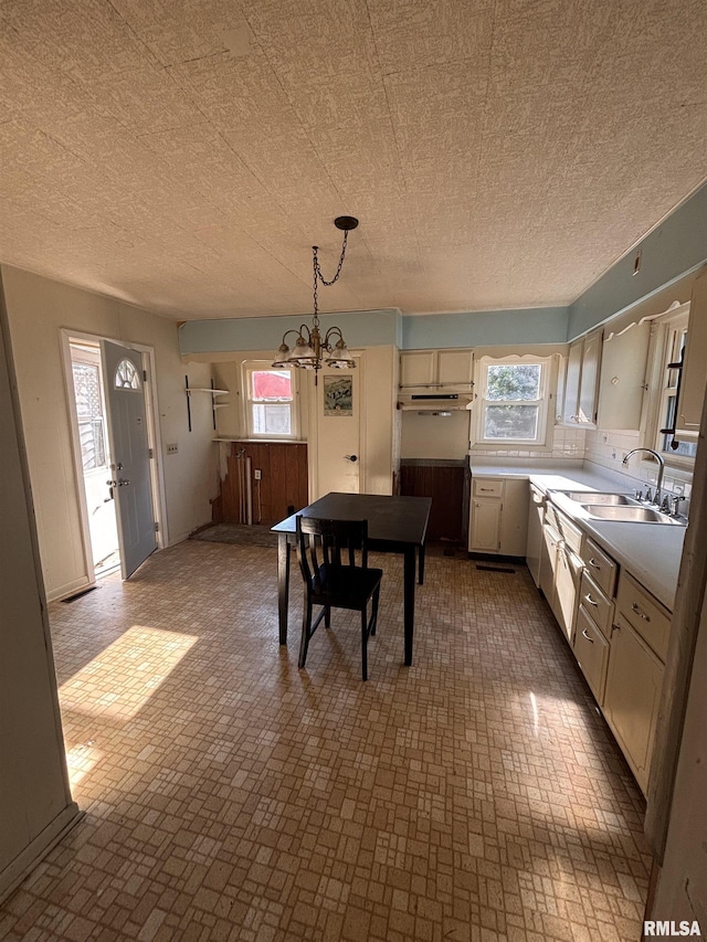 324 S Cottage St, Kewanee, IL 61443 - dining room featuring a chandelier, plenty of natural light, and a textured ceiling