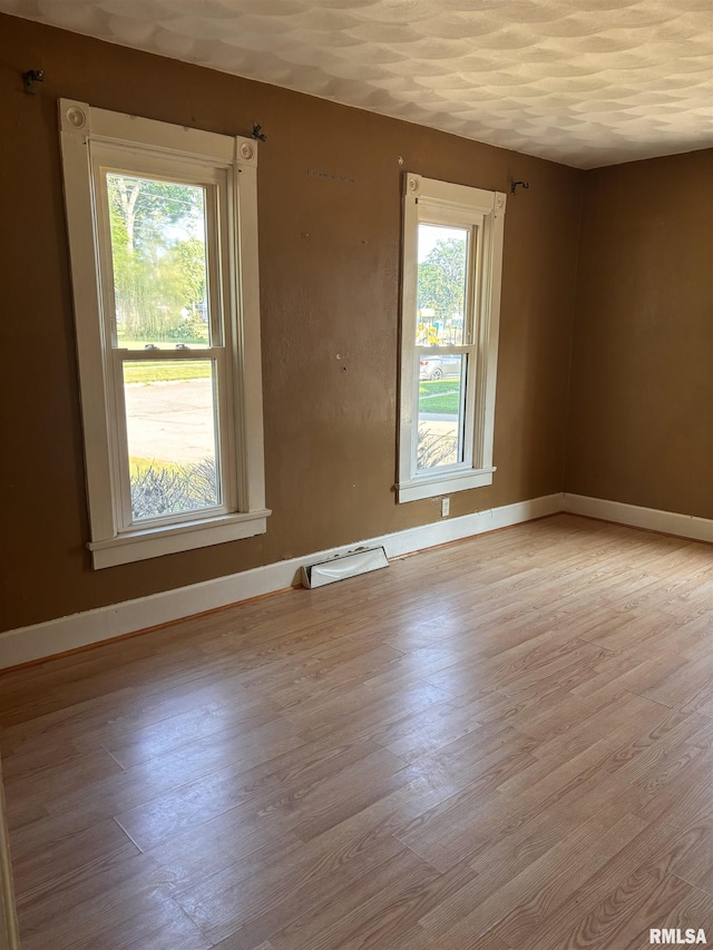 324 S Cottage St, Kewanee, IL 61443 - spare room with light wood-style floors and baseboards