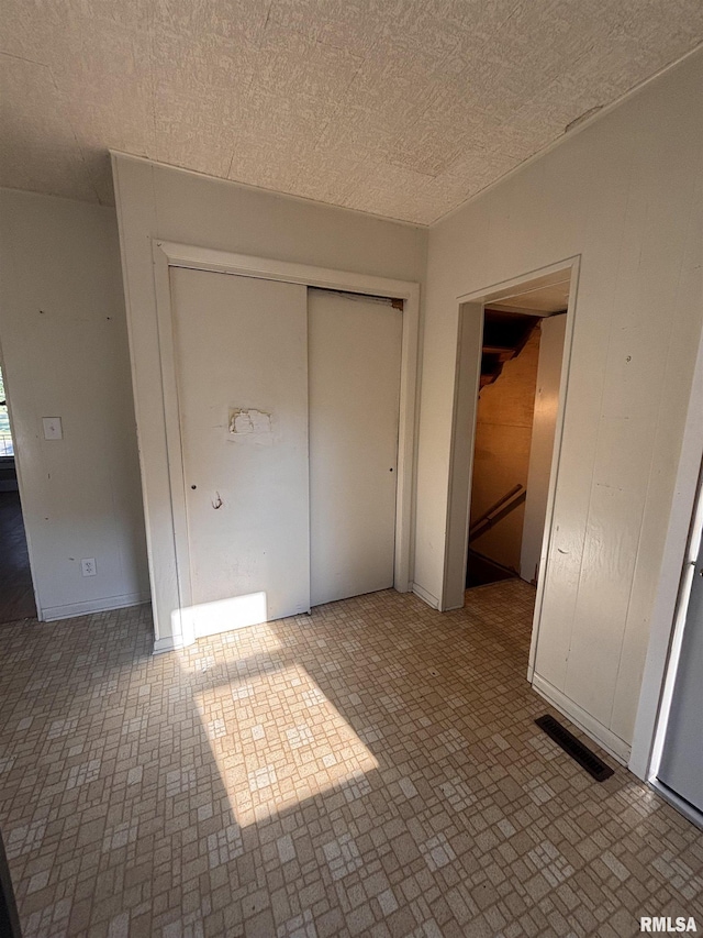 324 S Cottage St, Kewanee, IL 61443 - unfurnished bedroom featuring brick patterned flooring and a closet