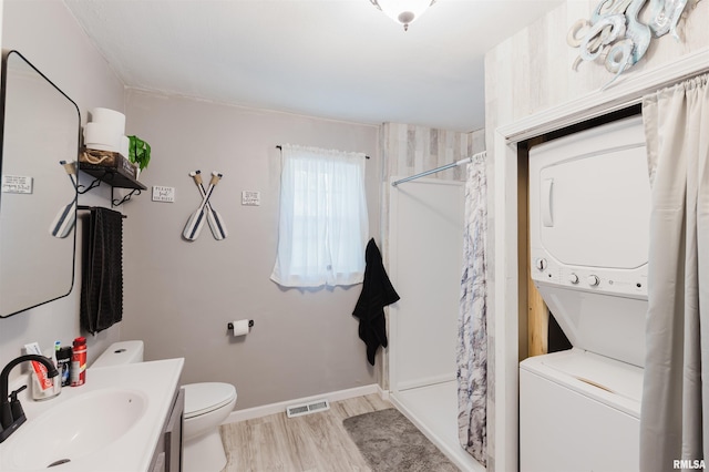 504 E Vermont St, Carterville, IL 62918 - full bathroom with stacked washer / drying machine, curtained shower, wood finished floors, and vanity