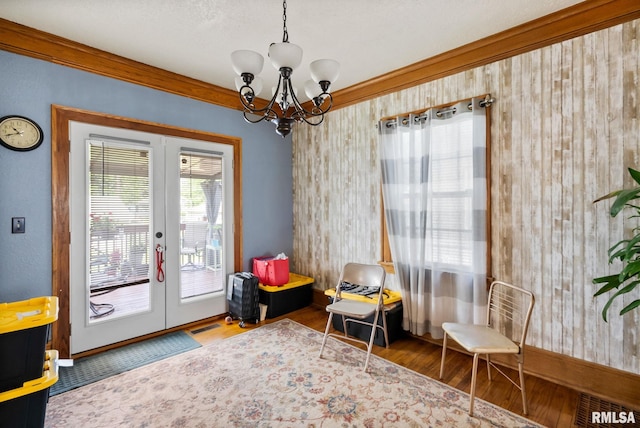 2016 12th St, Rock Island, IL 61201 - living area featuring french doors, wood finished floors, and a chandelier