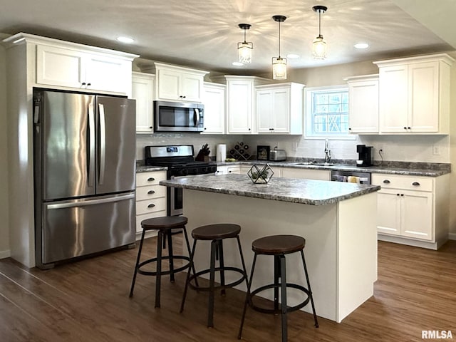 312 Mcvicker Dr, Energy, IL 62933 - kitchen with stainless steel appliances, a breakfast bar, a kitchen island, white cabinetry, and recessed lighting
