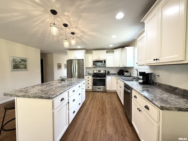 312 Mcvicker Dr, Energy, IL 62933 - kitchen with stainless steel appliances, dark wood-style floors, white cabinetry, a center island, and recessed lighting