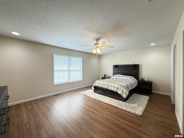 312 Mcvicker Dr, Energy, IL 62933 - bedroom with wood finished floors, a ceiling fan, recessed lighting, and a textured ceiling