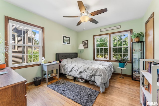3110 Arlington Ave, Davenport, IA 52803 - bedroom featuring multiple windows, light wood-type flooring, and ceiling fan