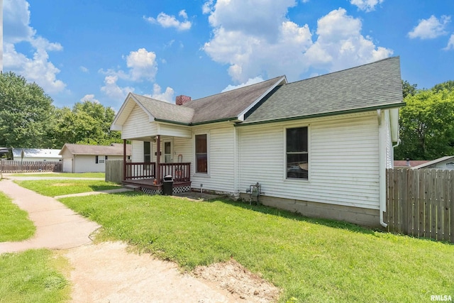 503 W Idaho Ave, Carterville, IL 62918 - view of front of house featuring roof with shingles, a porch, and a chimney