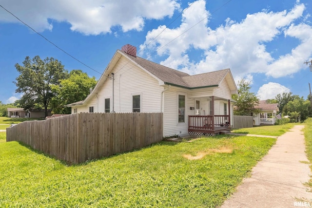 503 W Idaho Ave, Carterville, IL 62918 - view of home's exterior with a chimney, roof with shingles, and a wooden deck