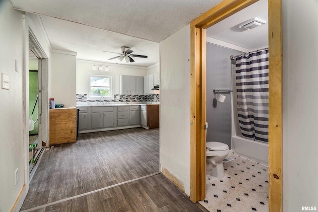 503 W Idaho Ave, Carterville, IL 62918 - bathroom with ornamental molding, wood finished floors, vanity, ceiling fan, and decorative backsplash