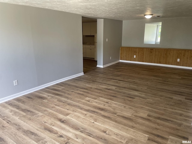 304 Lynda Dr Unit A/B, Carbondale, IL 62901 - unfurnished room with wood finished floors, a textured ceiling, and wainscoting