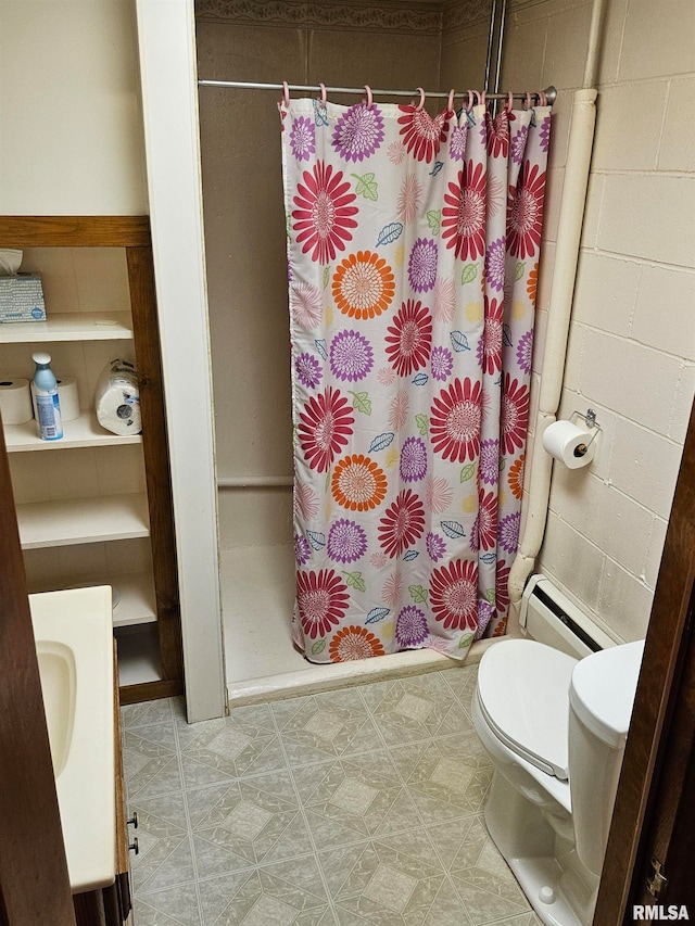 30154 395th Ave, Bellevue, IA 52031 - full bathroom featuring baseboard heating, a stall shower, vanity, and concrete block wall