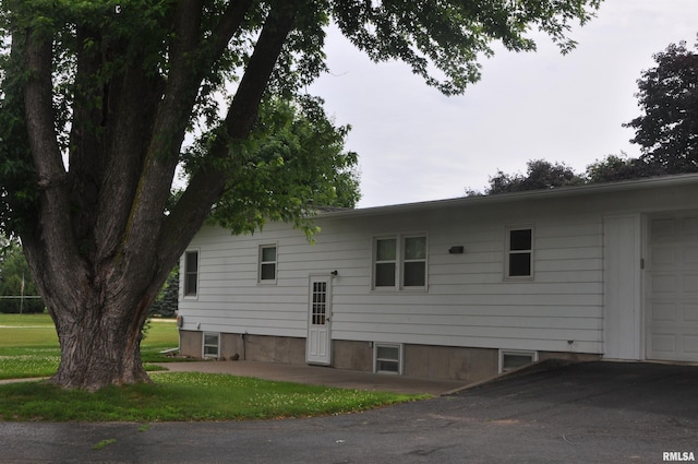 30154 395th Ave, Bellevue, IA 52031 - view of home's exterior with a garage, asphalt driveway, and a lawn