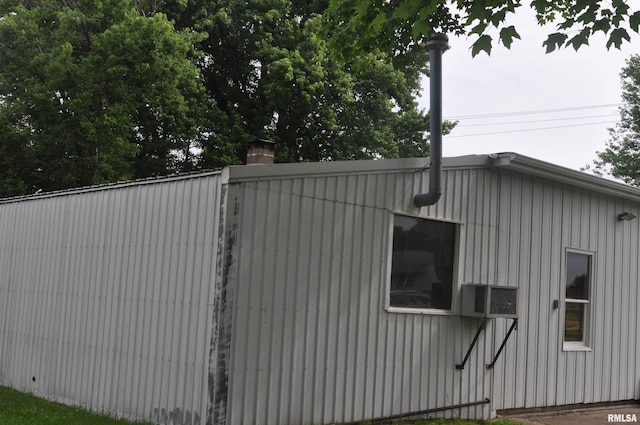 30154 395th Ave, Bellevue, IA 52031 - view of home's exterior with cooling unit, a chimney, and board and batten siding