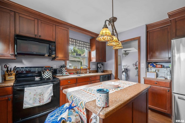 412 24th Ave, East Moline, IL 61244 - kitchen featuring black appliances, light countertops, pendant lighting, and a center island