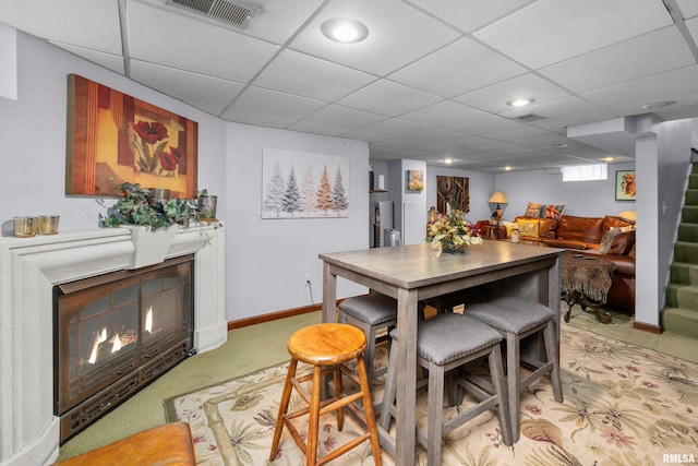412 24th Ave, East Moline, IL 61244 - dining space featuring a warm lit fireplace, light carpet, stairway, a drop ceiling, and recessed lighting