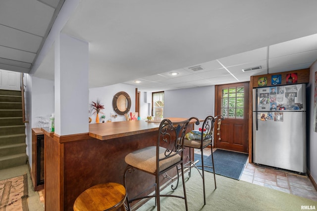 412 24th Ave, East Moline, IL 61244 - bar area with freestanding refrigerator, stairway, beverage cooler, and a drop ceiling