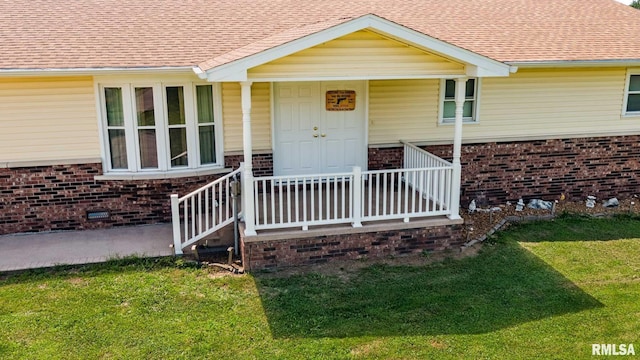1903 Melvin Rd, West Frankfort, IL 62896 - view of exterior entry featuring brick siding, a shingled roof, a yard, and a porch