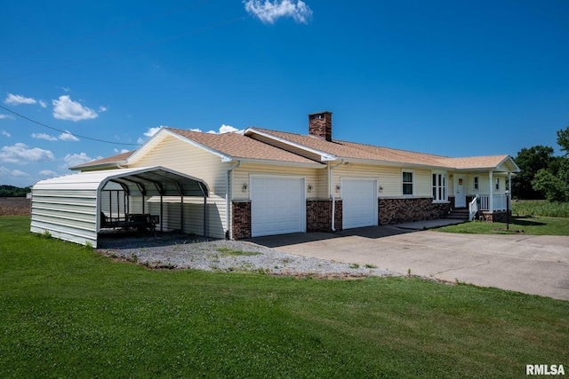 1903 Melvin Rd, West Frankfort, IL 62896 - view of front of property with a front yard, a garage, a chimney, and asphalt driveway
